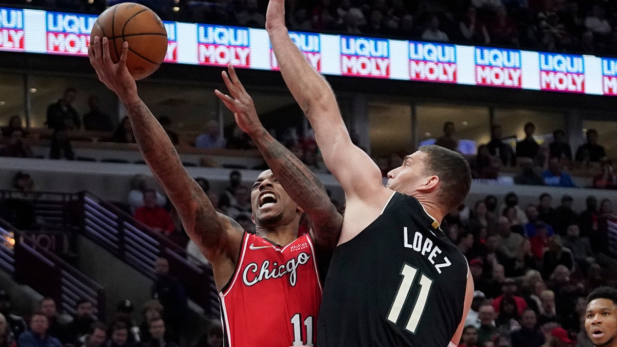 Milwaukee Bucks center Brook Lopez, right, defends against Chicago Bulls forward DeMar DeRozan during the first half of an NBA basketball game Tuesday, April 5, 2022, in Chicago.