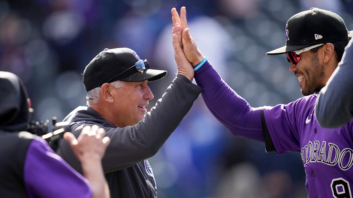 Colorado Rockies manager Bud Black, left, congratulates first baseman Connor Joe after the ninth inning of a baseball game against the Los Angeles Dodgers Sunday, April 10, 2022, in Denver.