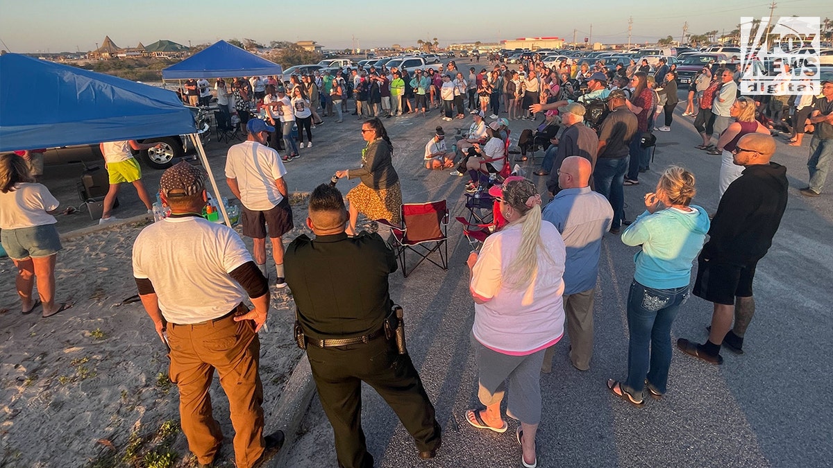 A crowd gathers at a vigil for Cassie Carli, a Florida mom who was found dead and buried in a shallow grave in a barn in Alabama on April 2, 2022.