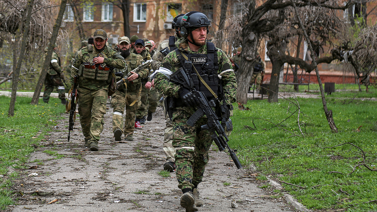 Fighters of the Chechen special forces unit walk in a courtyard in Mariupol, Ukraine, on Thursday, April 21.