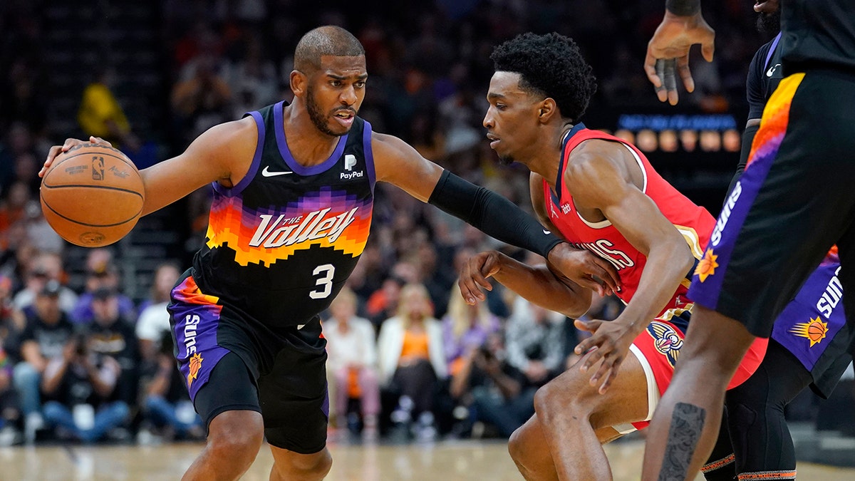 Phoenix Suns guard Chris Paul (3) drives as New Orleans Pelicans forward Herbert Jones defends during the first half of Game 1 of an NBA basketball first-round playoff series, Sunday, April 17, 2022, in Phoenix.