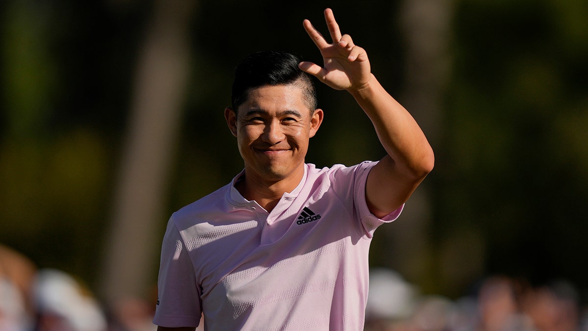 Collin Morikawa celebrates after holing out on the 18th hole for a birdie during the final round at the Masters golf tournament on Sunday, April 10, 2022, in Augusta, Ga.