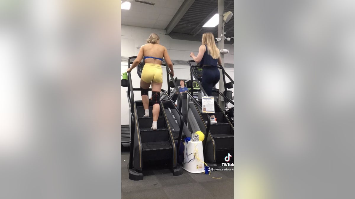 Olena Sadovska and a friend on a stair climber