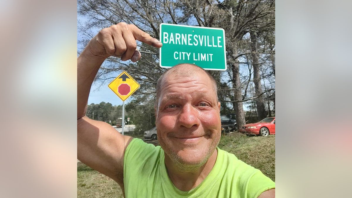 Bob Barnes in front of a Barnesville, Georgia sign