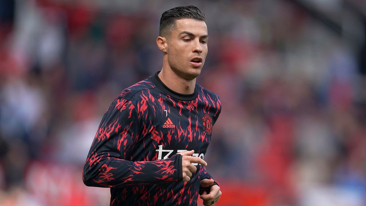 Manchester United's Cristiano Ronaldo warms up before the English Premier League soccer match between Manchester United and Norwich City at Old Trafford stadium in Manchester, England, Saturday, April 16, 2022.