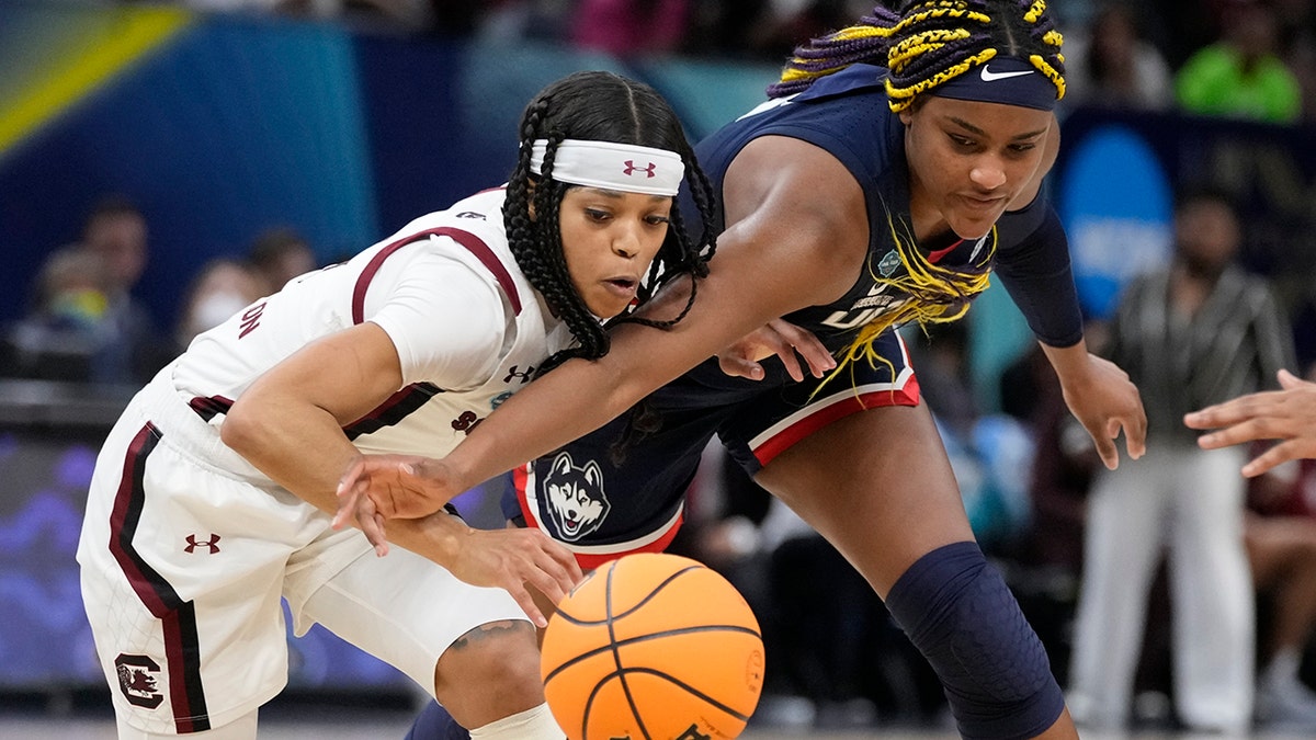 South Carolina's Destanni Henderson and UConn's Aaliyah Edwards go after a loose ball during the second half of a college basketball game in the final round of the Women's Final Four NCAA tournament Sunday, April 3, 2022, in Minneapolis.