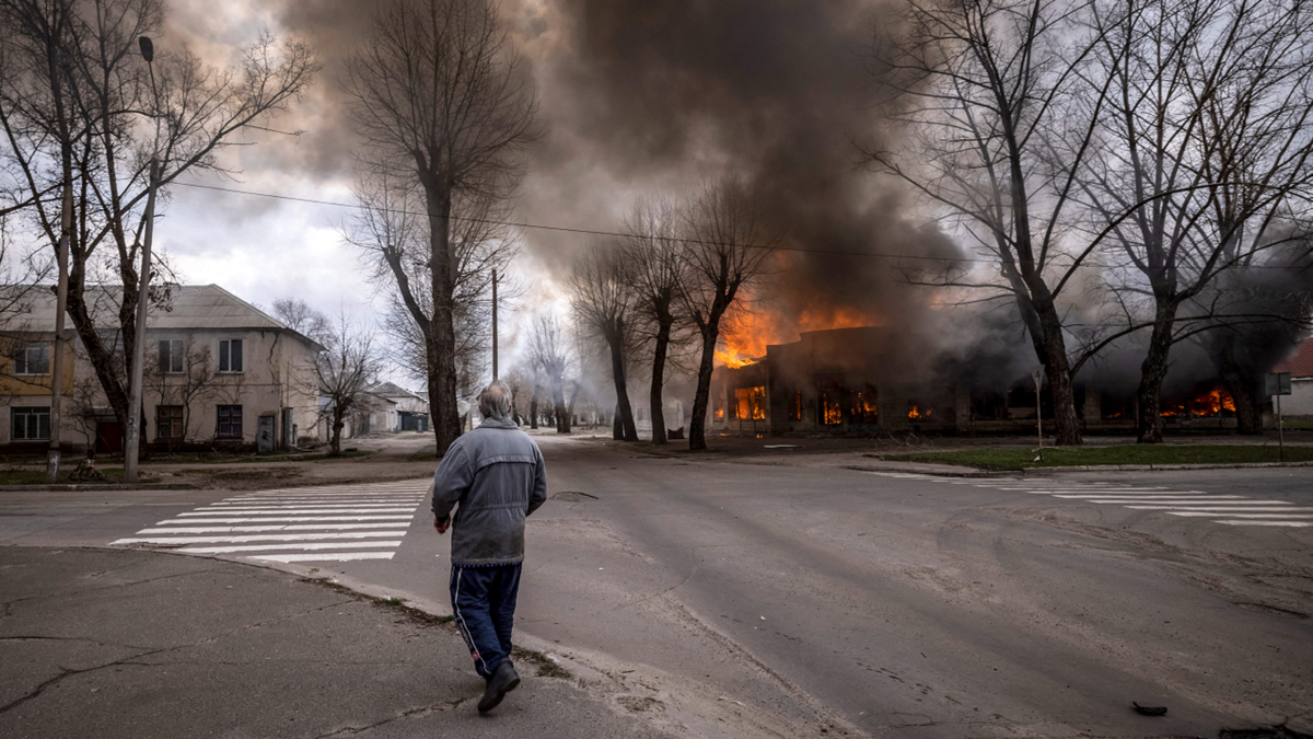 A man surveys damage from Russia's invasion of Ukraine in Sievierodonetsk, Ukraine