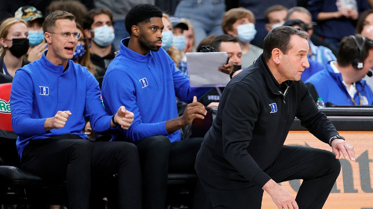 Associate head coach Jon Scheyer and director of player development Amile Jefferson of the Duke Blue Devils look on as head coach Mike Krzyzewski of the Blue Devils reacts during the Continental Tire Challenge against the Gonzaga Bulldogs at T-Mobile Arena on November 26, 2021 in Las Vegas, Nevada. The Blue Devils defeated the Bulldogs 84-81.