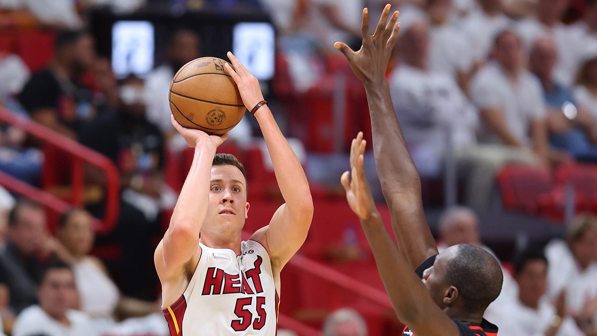 Duncan Robinson #55 of the Miami Heat shoots a three pointer over Gorgui Dieng #10 of the Atlanta Hawks during the second half in Game One of the Eastern Conference First Round at FTX Arena on April 17, 2022 in Miami, Florida.