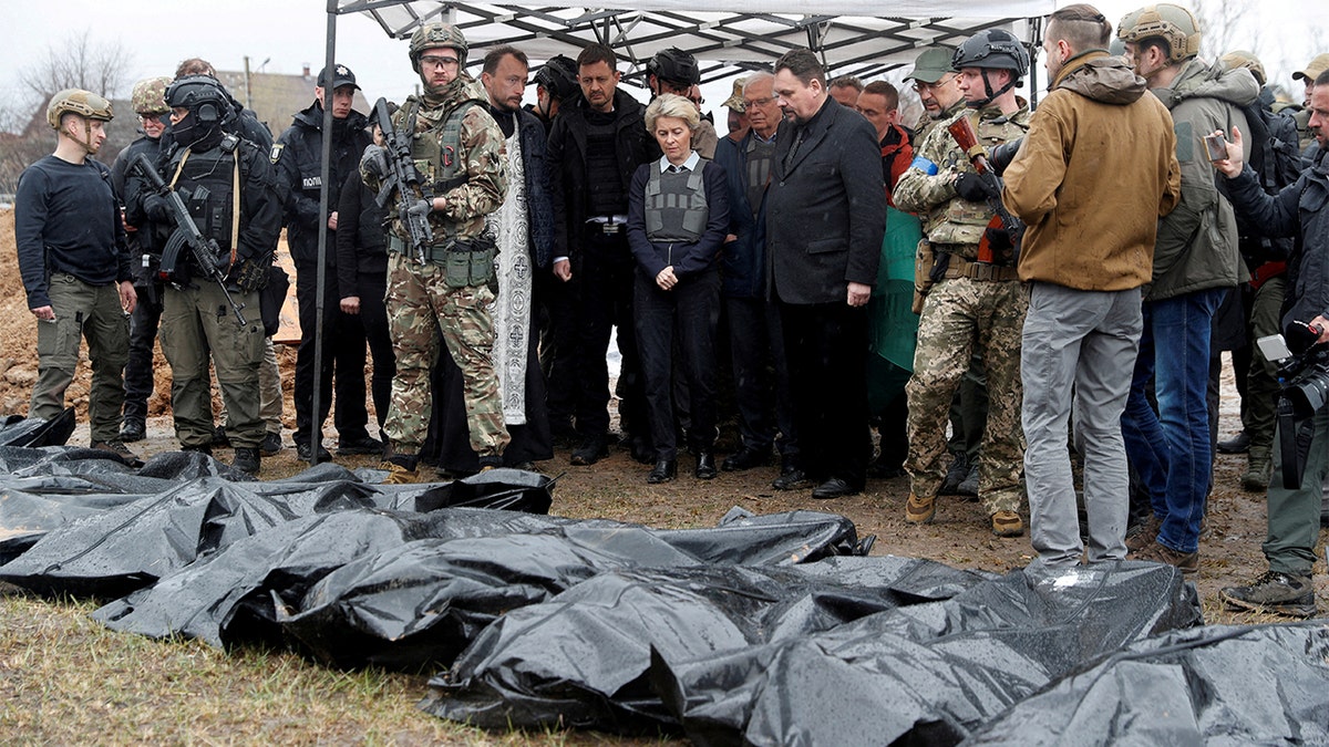 European Commission President Ursula von der Leyen, High Representative of the European Union for Foreign Affairs and Security Policy Josep Borrell, Slovakia's Prime Minister Eduard Heger and Ukraine's Prime Minister Denys Shmyhal stand next to a mass grave as they visit the town of Bucha, as Russia's attack on Ukraine continues, outside of Kyiv, Ukraine April 8, 2022. REUTERS/Valentyn Ogirenko
