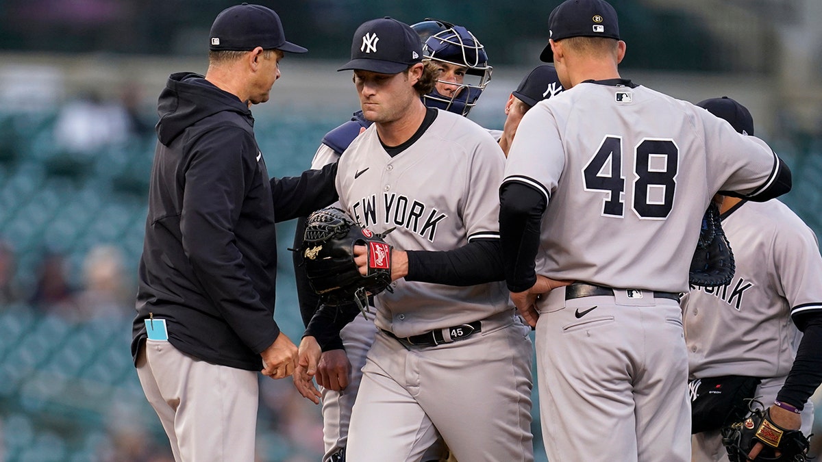 New York Yankees manager Aaron Boone takes the ball from pitcher Gerrit Cole against the Detroit Tigers in the second inning of a baseball game in Detroit, Tuesday, April 19, 2022.