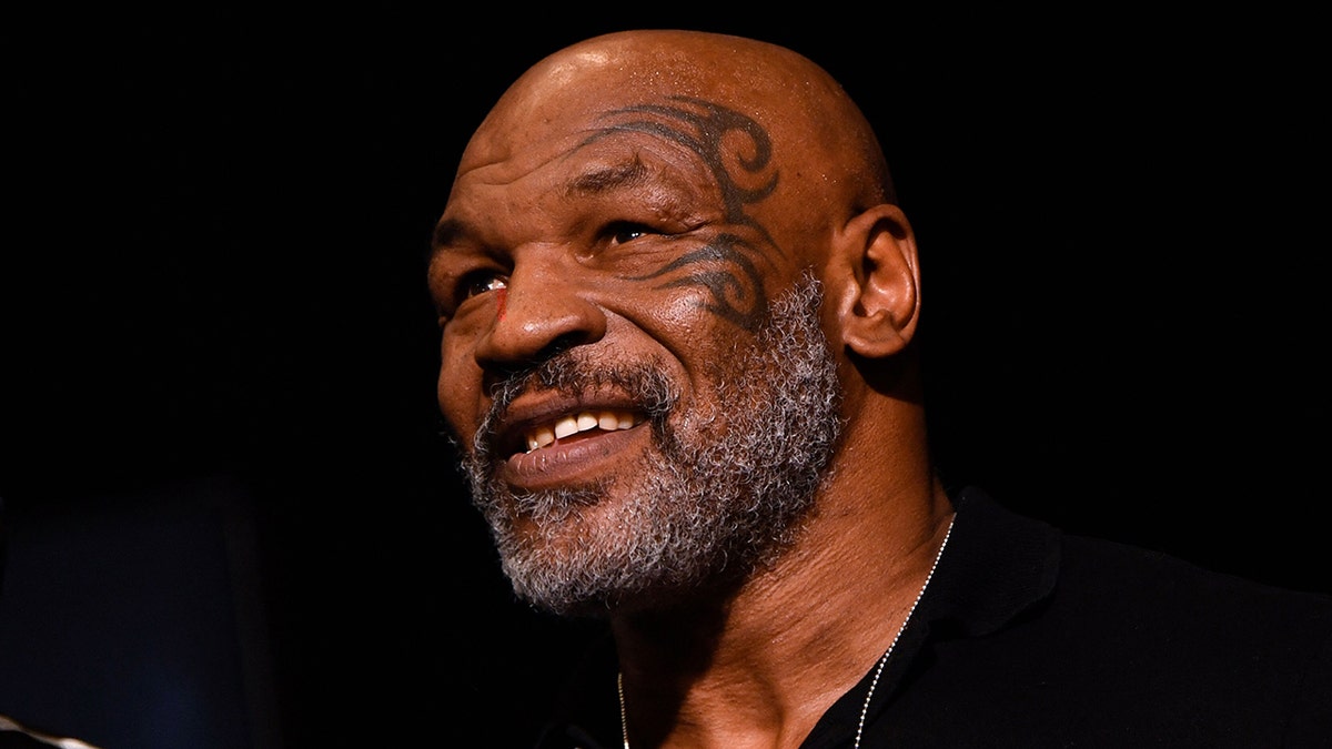 Mike Tyson shows off his face tattoo