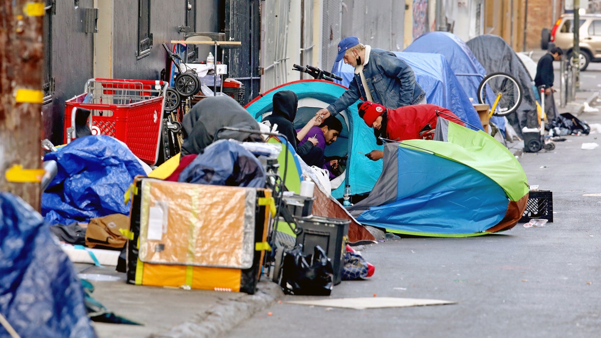 Homeless people consume illegal drugs in an encampment along Willow St. in the Tenderloin district of downtown on Thursday, Feb. 24, 2022 in San Francisco, CA. London Breed, mayor of San Francisco, is the 45th mayor of the City and County of San Francisco. She was supervisor for District 5 and was president of the Board of Supervisors from 2015 to 2018.