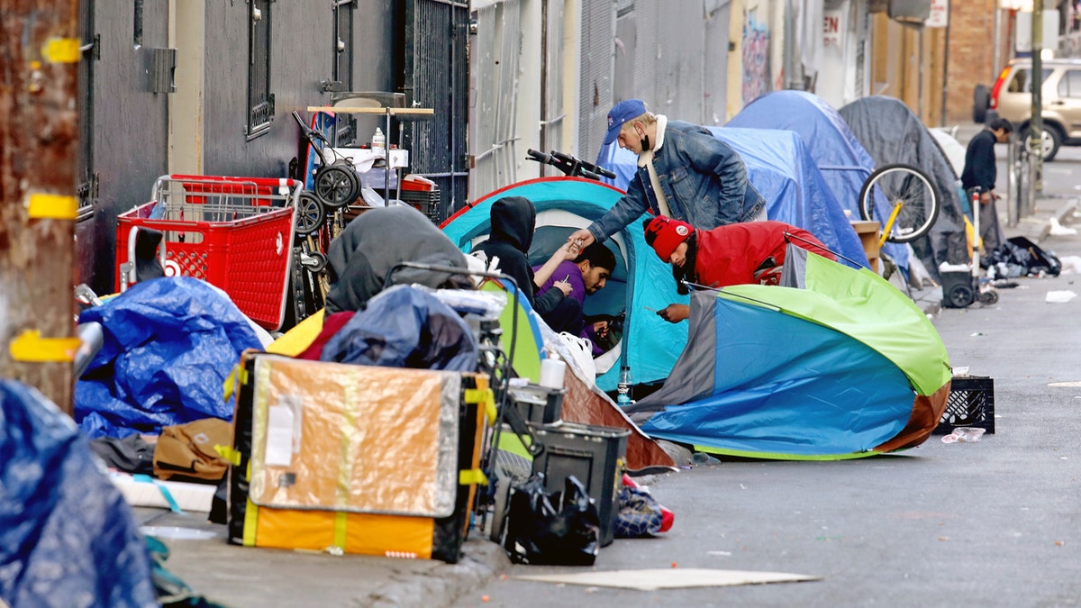 Homeless people consume illegal drugs in an encampment along Willow St. in the Tenderloin district of downtown on Thursday, Feb. 24, 2022 in San Francisco, CA. London Breed, mayor of San Francisco, is the 45th mayor of the City and County of San Francisco. She was supervisor for District 5 and was president of the Board of Supervisors from 2015 to 2018.