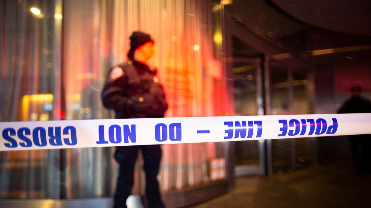 A New York City police officer stands behind a police line at the entrance of the Museum of Modern Art in New York City on March 12, 2022. - Two people were stabbed at New York's prestigious Museum of Modern Art on Saturday, police said, causing the museum to be evacuated. (Photo by Kena Betancur / AFP) (Photo by KENA BETANCUR/AFP via Getty Images)