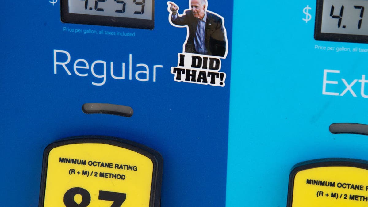 A gas pump displays fuel prices, along with a sticker of President Joe Biden, at a gas station in Arlington, Virginia, on March 16, 2022.