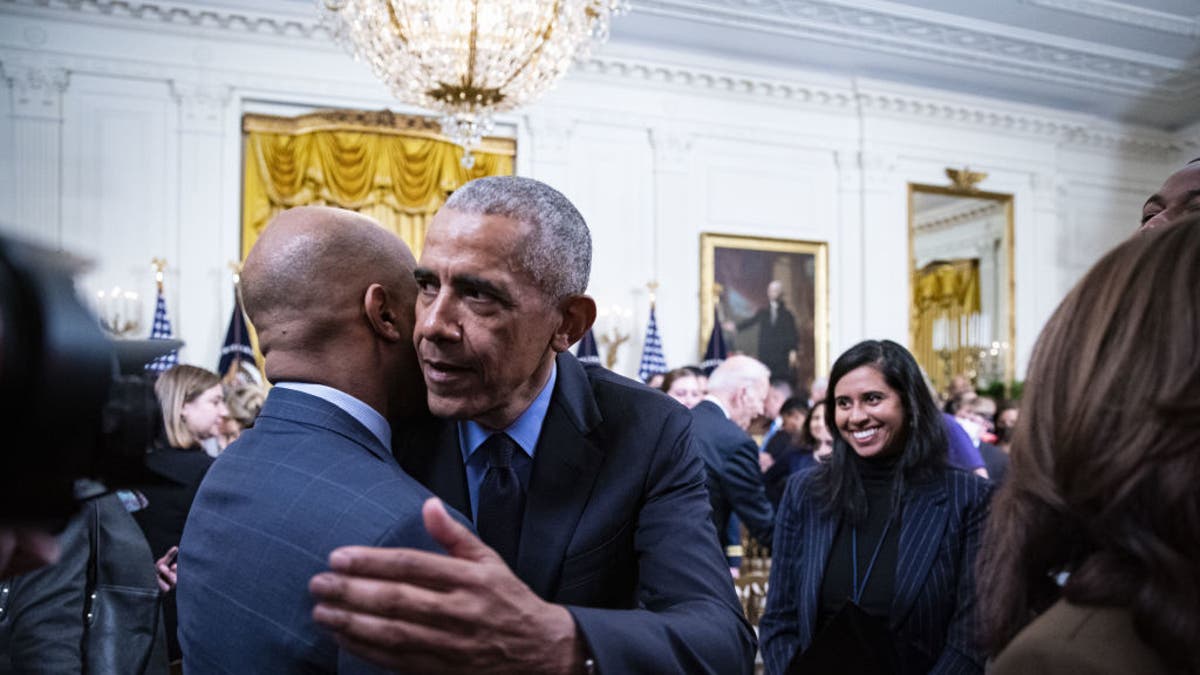Former President Barack Obama hugs Jamal Simmons following an event about the Affordable Care Act and lowering health care costs for families in the East Room of the White House in Washington, D.C., on April 5, 2022.