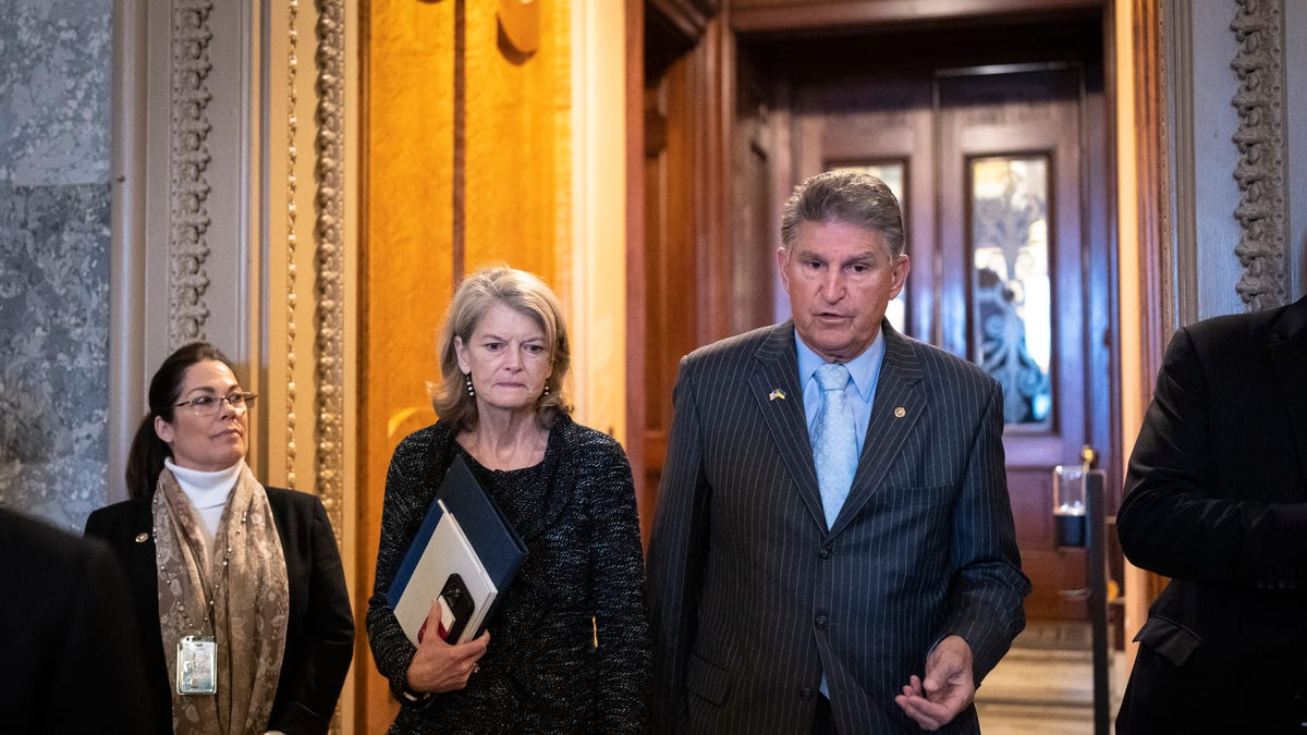 Sen. Lisa Murkowski (R-AK) talks with Sen. Joe Manchin (D-WV) outside the Senate Chamber at the U.S. Capitol on April 7, 2022 in Washington, DC.