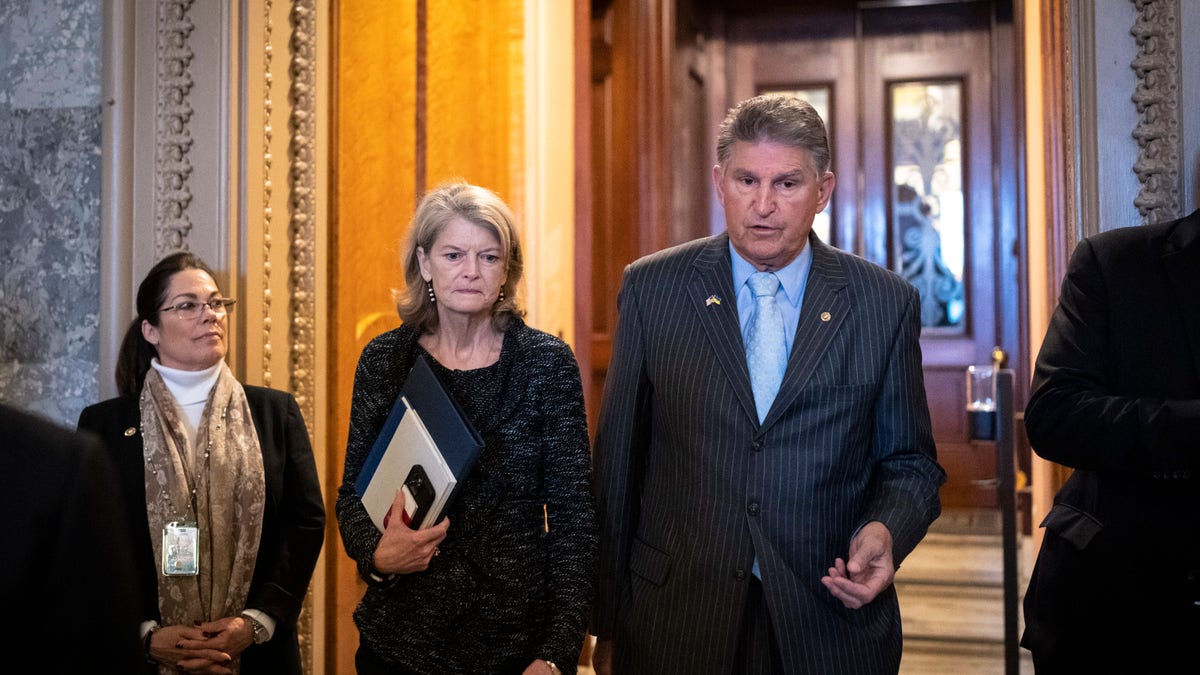 Sen. Lisa Murkowski (R-AK) talks with Sen. Joe Manchin (D-WV) outside the Senate Chamber at the U.S. Capitol on April 7, 2022 in Washington, DC.