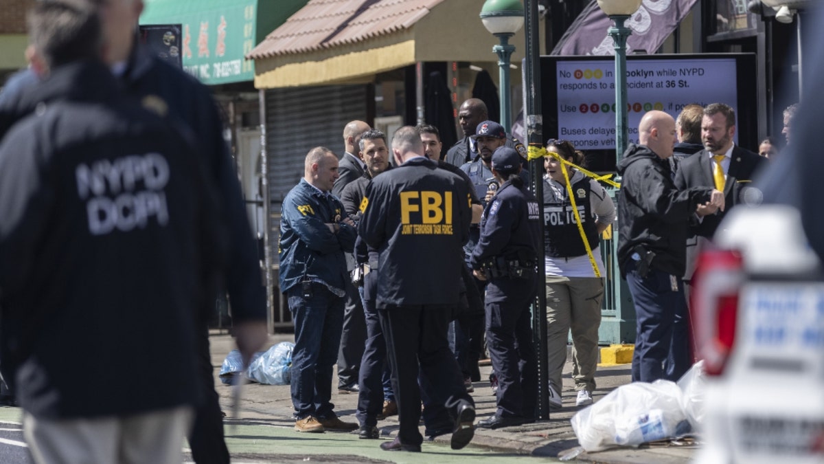 Law enforcement officers at the scene of a shooting at the 36th Street subway station in the Sunset Park neighborhood in the Brooklyn borough of New York, U.S., on Tuesday, April 12, 2022. A New York City shooter remains at large after 16 people were injured, including 10 people with gunshot wounds, during a chaotic Tuesday morning-rush-hour incident at a subway station in Sunset Park, Brooklyn. 