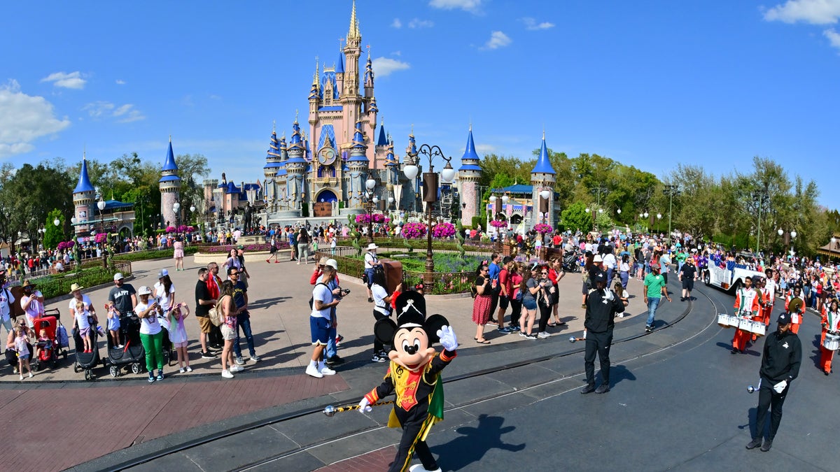 Mickey Mouse waves at Walt Disney World in Florida