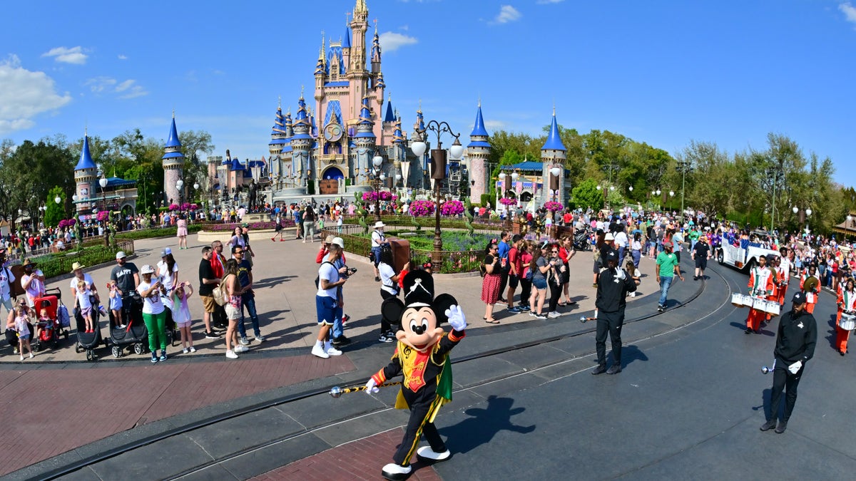 Mickey Mouse waves at Walt Disney World in Florida