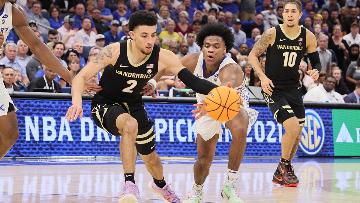 Sahvir Wheeler #2 of the Kentucky Wildcats and Scotty Pippen Jr. #2 of the Vanderbilt Commodores reach for a loose ball during the quarterfinals of the 2022 SEC Men's Basketball Tournament at Amalie Arena on March 11, 2022 in Tampa, Florida.