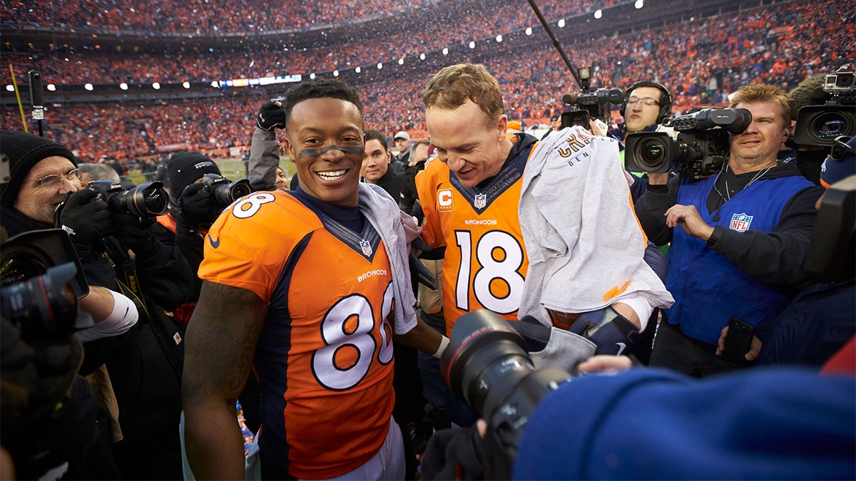 Denver Broncos QB Peyton Manning (18) with Demaryius Thomas (88) after winning game vs New Engalnd Patriots at Sports Authority Field at Mile High in Denver, Colorado, on January 24, 2016.