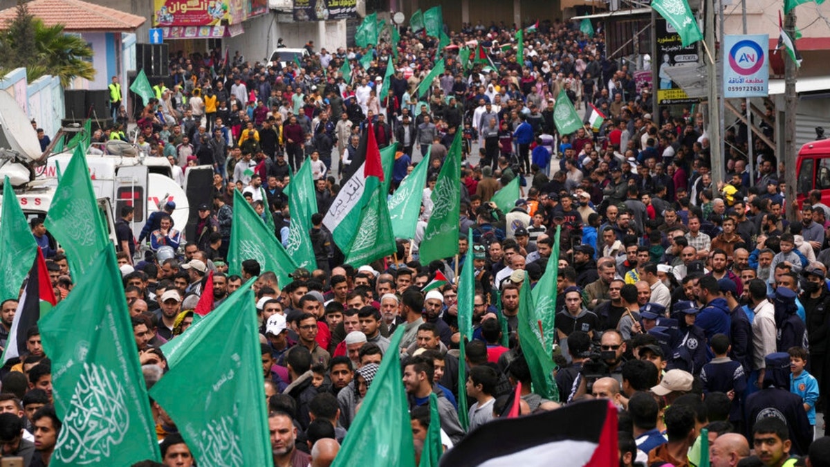 Hamas supporters wave green Islamic flags during a rally