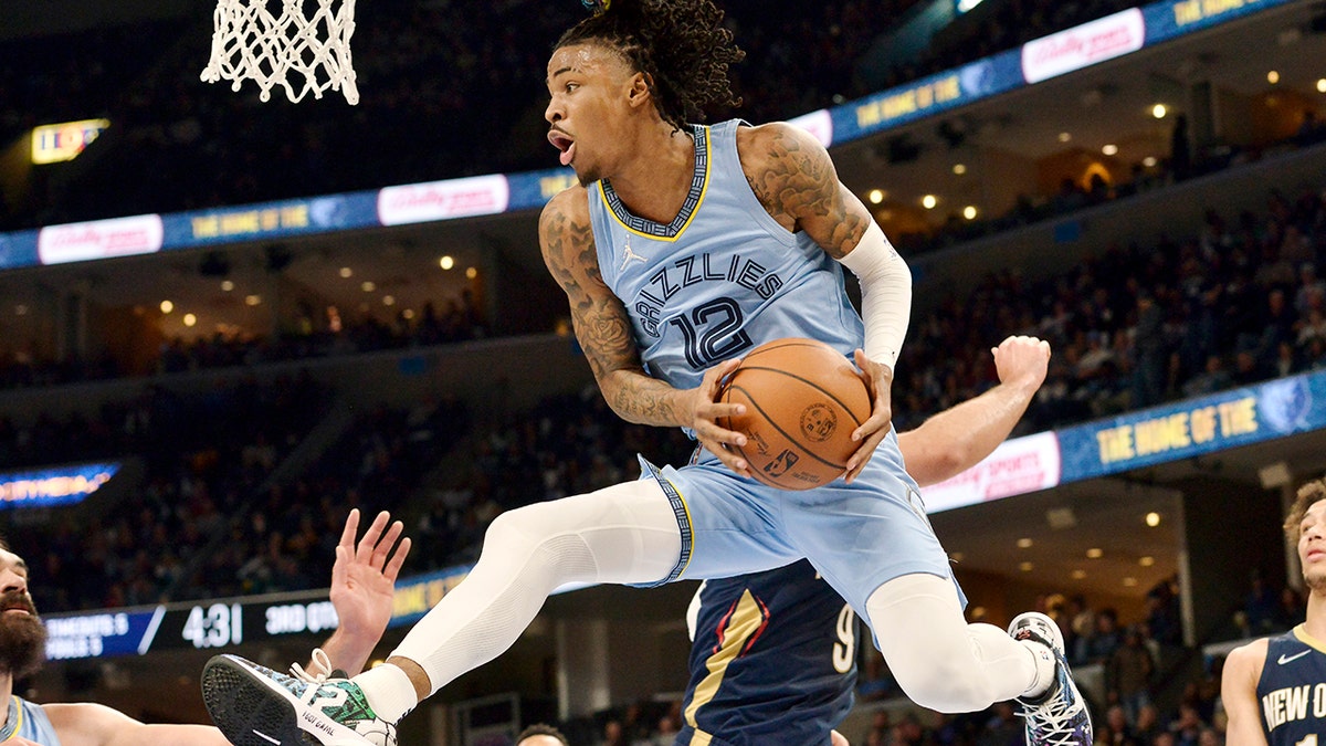 Memphis Grizzlies guard Ja Morant (12) handles the ball under the basket during the second half of the team's NBA basketball game against the New Orleans Pelicans onSaturday, April 9, 2022, in Memphis, Tenn.
