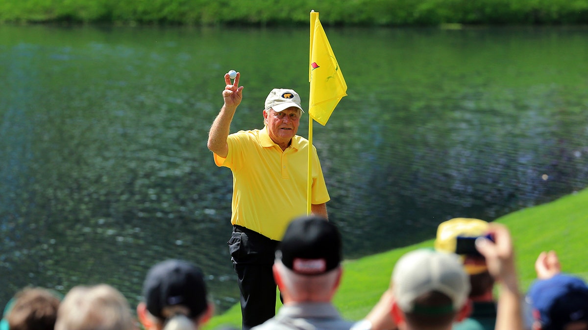 Patrons watch as Jack Nicklaus celebrates his hole-in-one on the fourth hole during the Par 3 Contest prior to the start of the 2015 Masters Tournament at Augusta National Golf Club on April 8, 2015 in Augusta, Georgia.