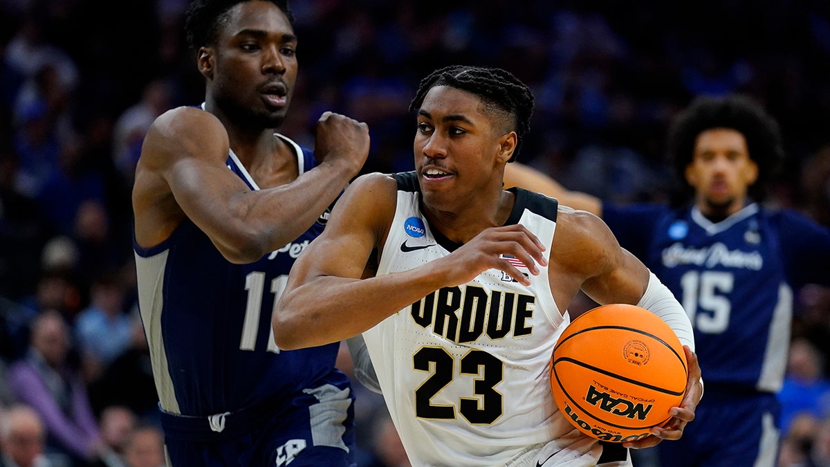 Purdue's Jaden Ivey (23) drives past Saint Peter's KC Ndefo (11) during the second half of a college basketball game in the Sweet 16 round of the NCAA tournament, Friday, March 25, 2022, in Philadelphia.
