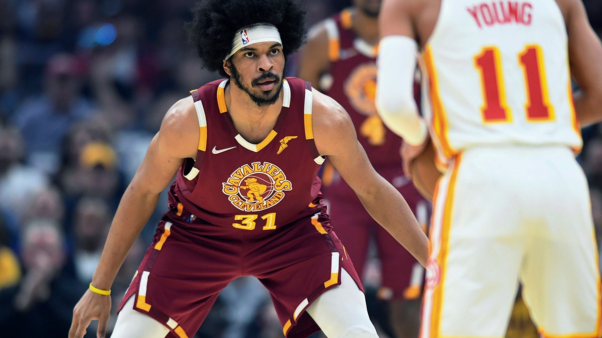 Cleveland Cavaliers' Jarrett Allen (31) defends Atlanta Hawks Trae Young (11) during the first half of an NBA play-in basketball game Friday, April 15, 2022, in Cleveland. 