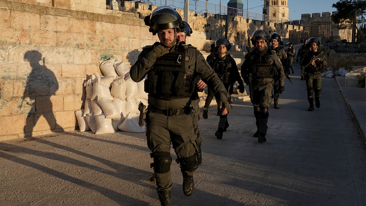Israeli security forces gather during clashes with Palestinian demonstrators at the Al Aqsa Mosque compound in Jerusalem's Old City Friday, April 15, 2022. (AP Photo/Mahmoud Illean)