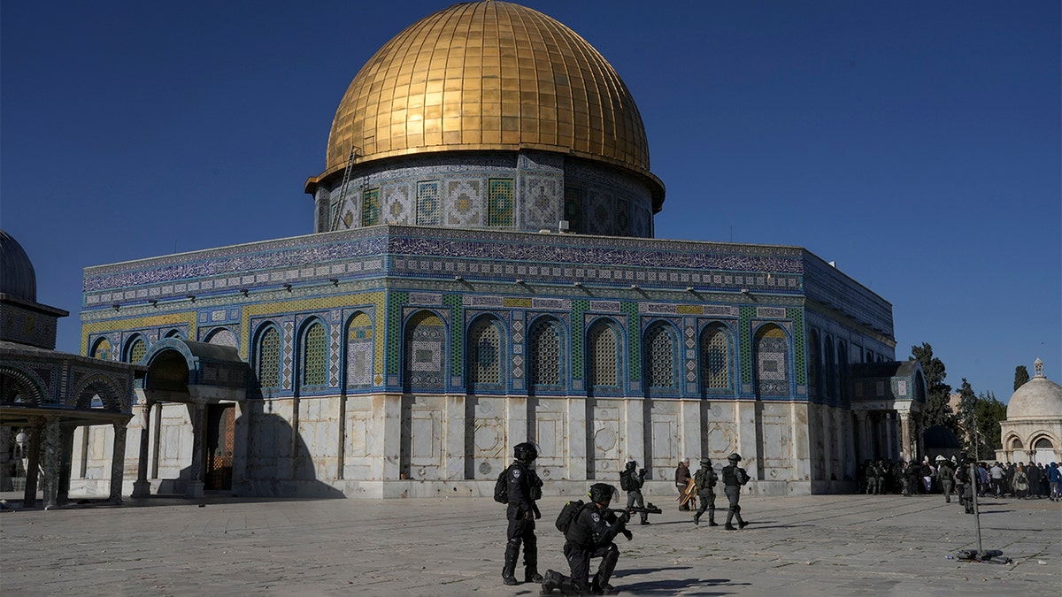 Israeli security forces take position during clashes with Palestinians demonstrators in front of the Dome of the Rock shrine at the Al Aqsa Mosque compound in Jerusalem's Old City, Friday, April 15, 2022. (AP Photo/Mahmoud Illean)