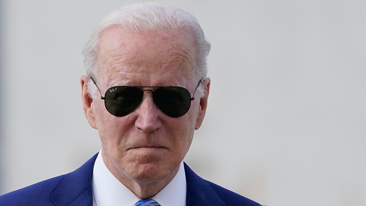 President Biden walks across the tarmac to speak to the media before boarding Air Force One