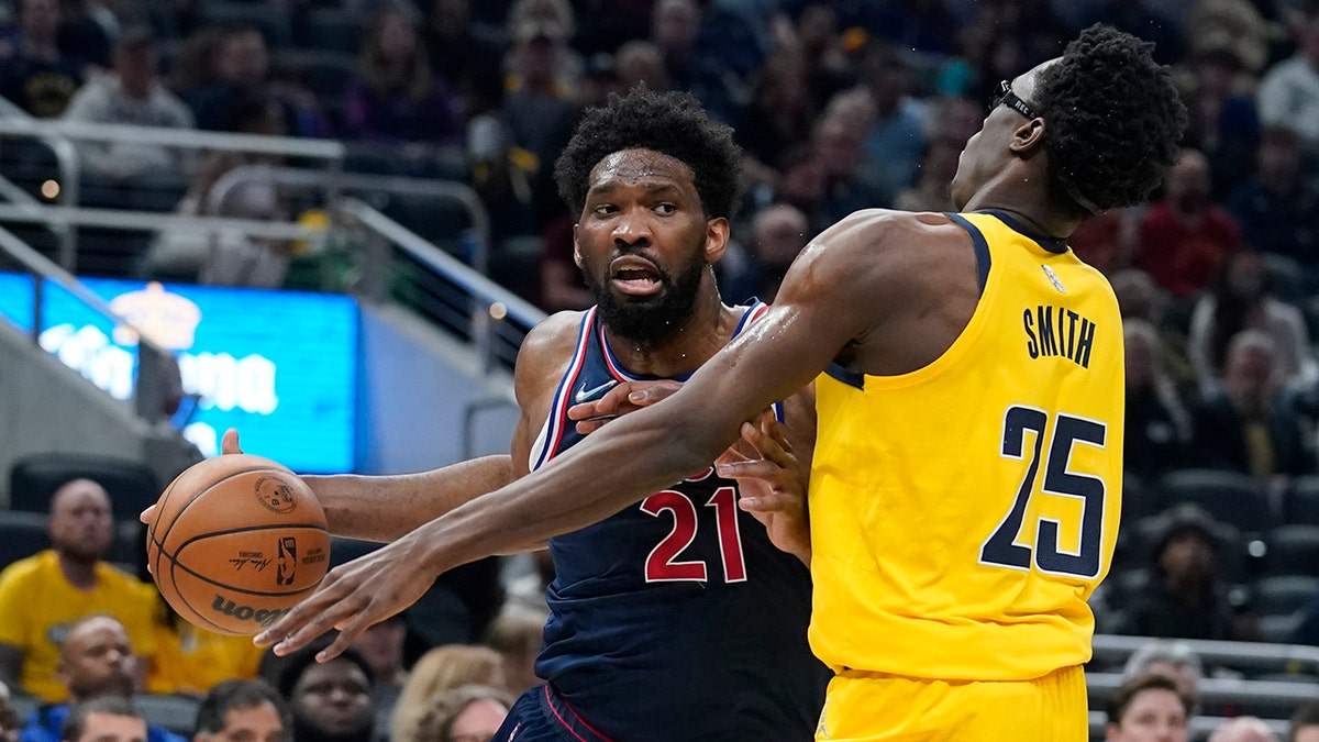 Philadelphia 76ers' Joel Embiid goes to the basket against Indiana Pacers' Jalen Smith during the first half of an NBA basketball game Tuesday, April 5, 2022, in Indianapolis.