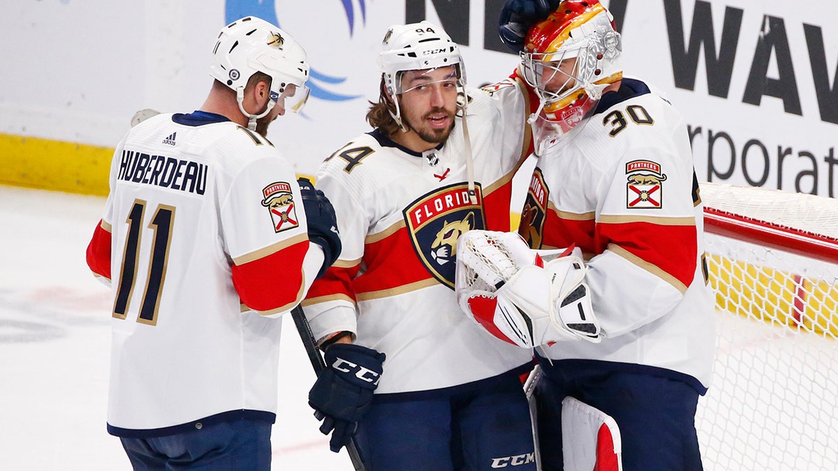 Florida Panthers left wing Jonathan Huberdeau (11) and left wing Ryan Lomberg (94) celebrate a victory with goaltender Spencer Knight (30) following the third period of an NHL hockey game against the Buffalo Sabres, Sunday, April 3, 2022, in Buffalo, N.Y.