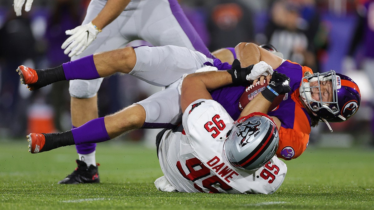 Zac Dawe #95 of Tampa Bay Bandits at Protective Stadium sacks Josh Love #12 of Pittsburgh Maulers in the third quarter of the game on April 18, 2022 in Birmingham, Alabama.