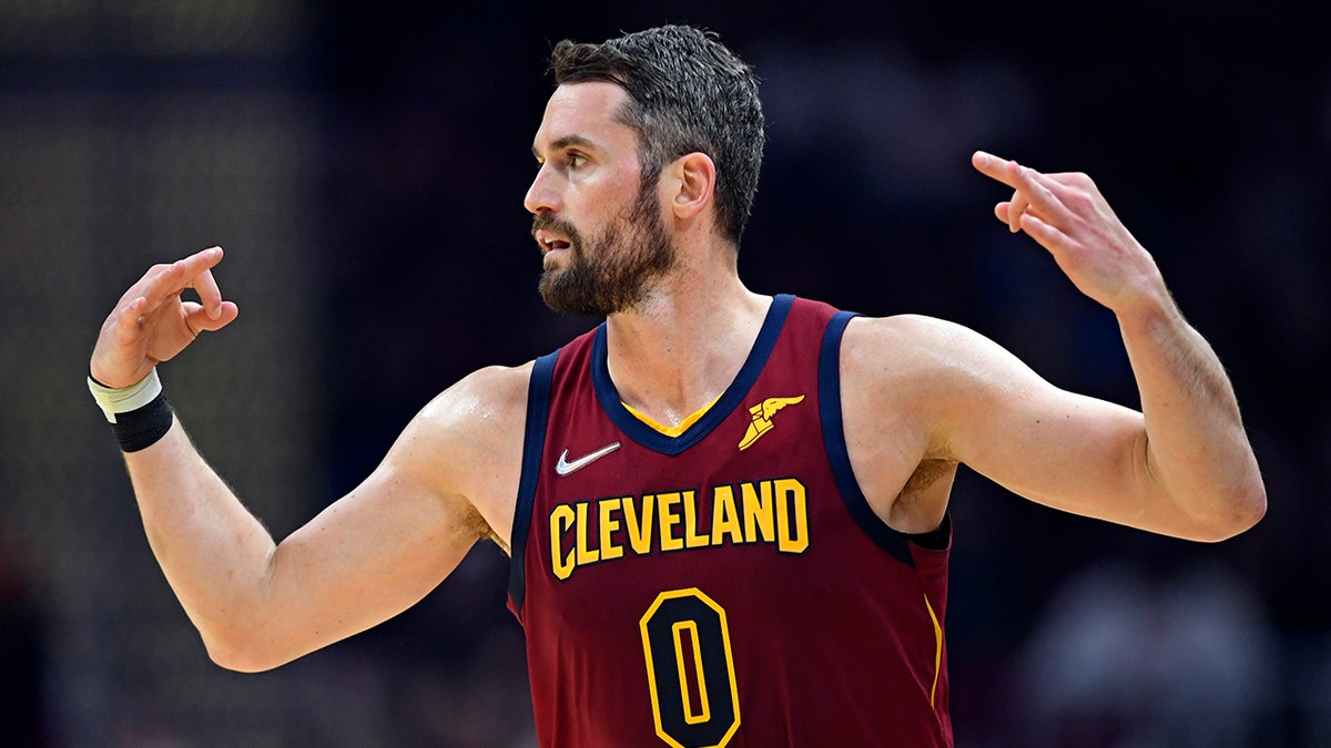 Cleveland Cavaliers forward Kevin Love celebrates after a 3-point basket in the first half of an NBA basketball game against the Milwaukee Bucks, Sunday, April 10, 2022, in Cleveland.