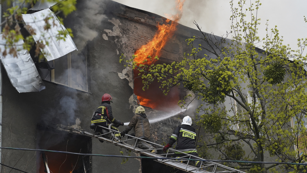 Firefighters work to extinguish fire at an apartments building after a Russian attack in Kharkiv, Ukraine, on Sunday.