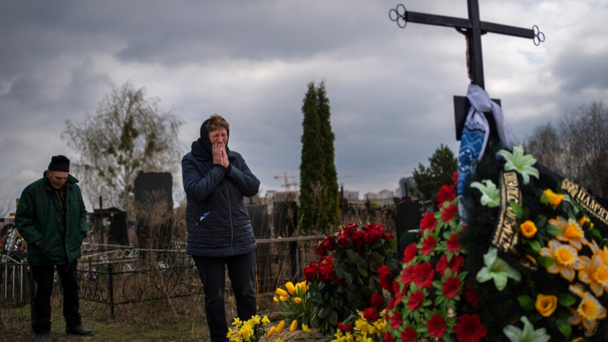 A mother grieves her son at a Bucha cemetery