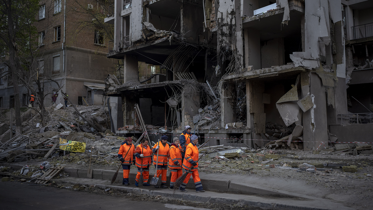 Clean-up crews prepare to work on Friday, April 29 at the site of an explosion in Kyiv, Ukraine. 