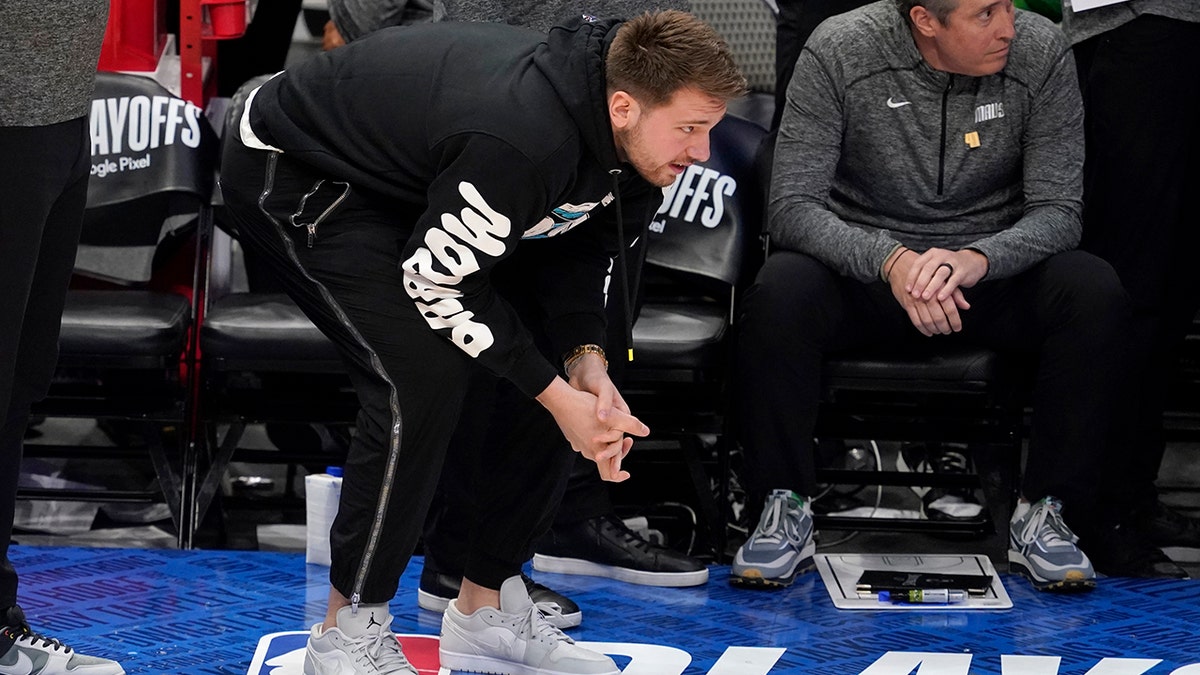Dallas Mavericks' Luka Doncic leans down as he watches play late in the second half of Game 1 of an NBA basketball first-round playoff series against the Utah Jazz, Saturday, April 16, 2022, in Dallas.
