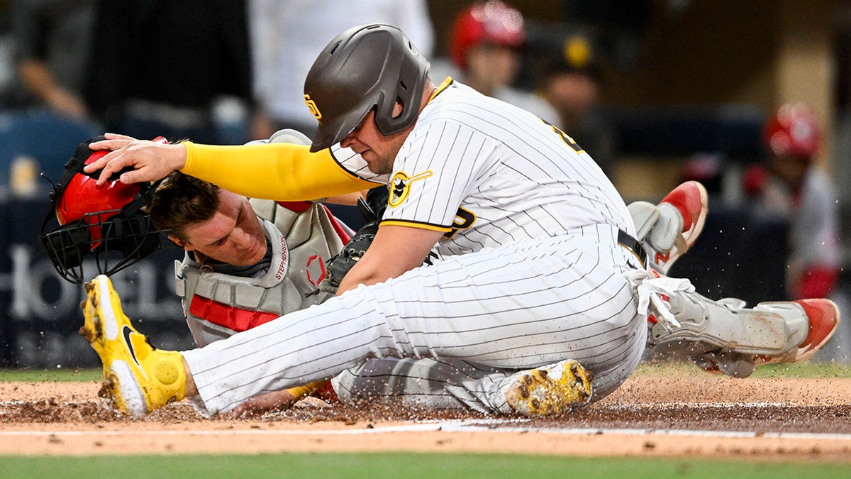 Padres' Luke Voit collides with Reds' Tyler Stephenson at plate, tensions  boil