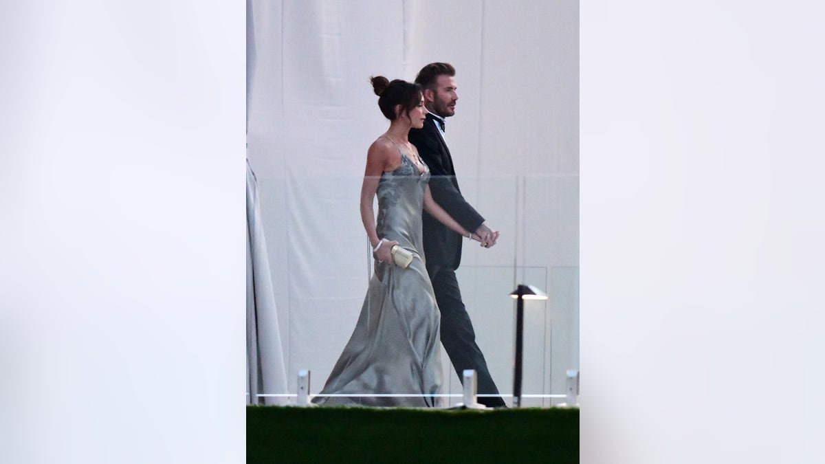 David Beckham and his wife Victoria Beckham enter the dinner tent after their son Brooklyn Beckham married Nicola Peltz in Palm Beach, Florida.