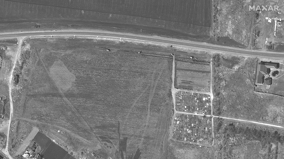 On March 26, the first rows of graves start to appear. (Satellite image ©2022 Maxar Technologies)