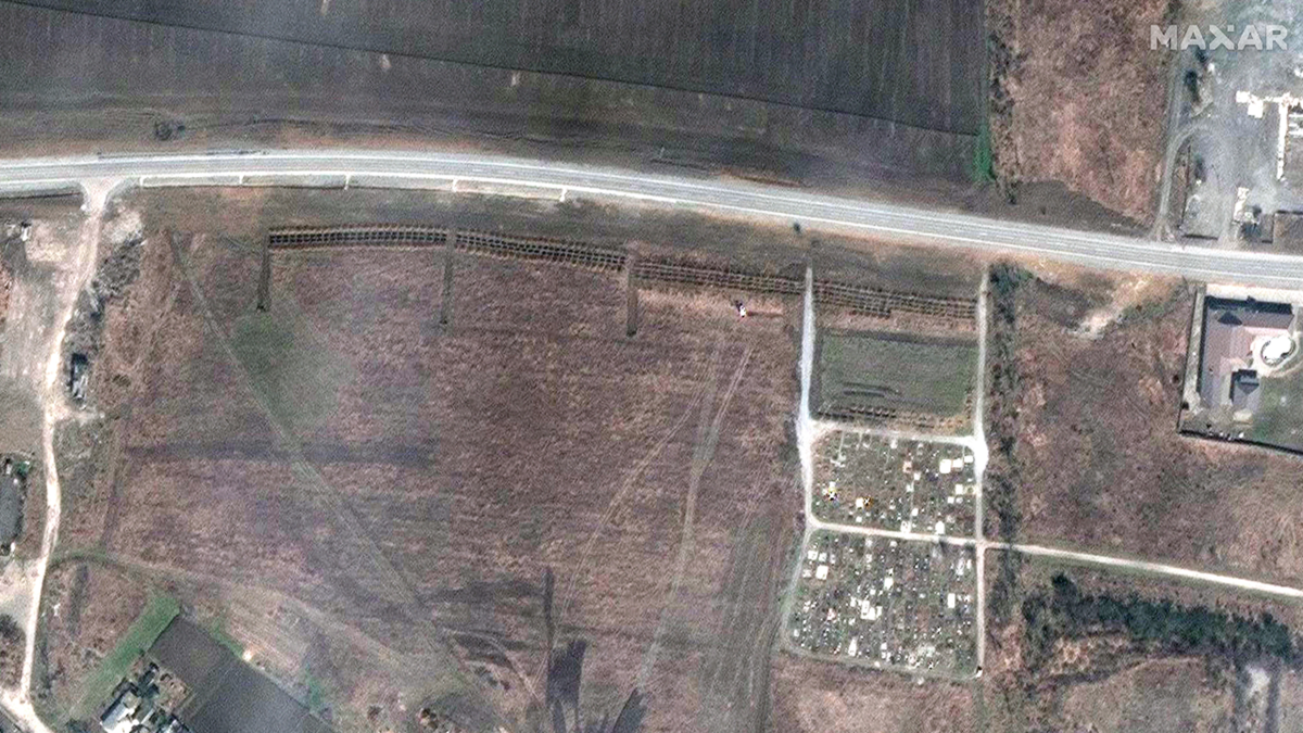 By April 3, columns of graves can be seen at the site in Manhush, Ukraine. (Satellite image ©2022 Maxar Technologies)