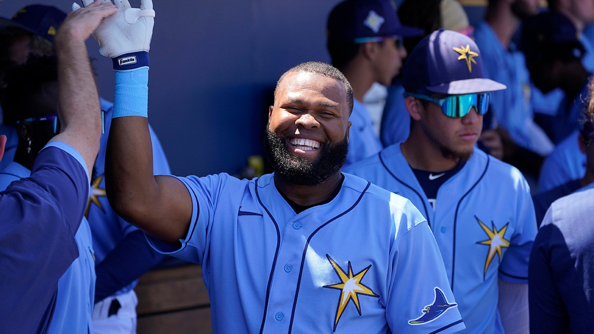 Tampa Bay Rays right fielder Manuel Margot (13) gets a welcome back to the dugout after a home run during a spring training baseball game against the Minnesota Twins at the Charlotte Sports Park Tuesday March 29, 2022, in Port Charlotte, Fla.
