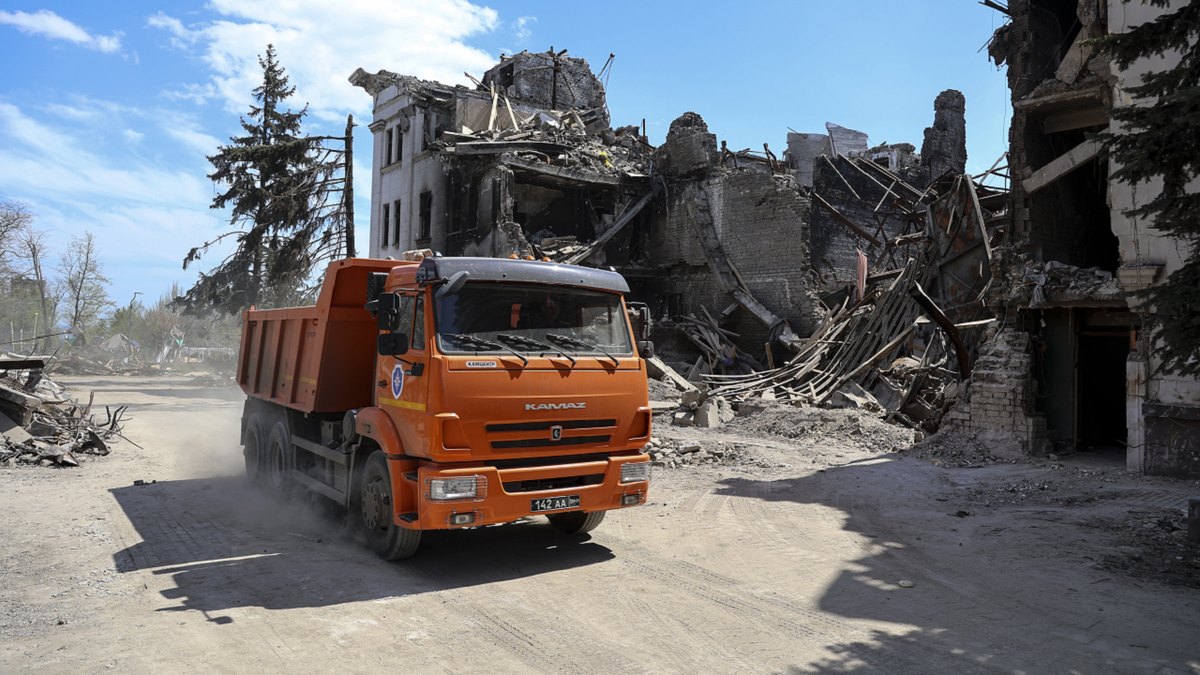 A truck drives past the Mariupol theater damaged during fighting in Mariupol, in territory under the government of the Donetsk People's Republic, eastern Ukraine, on Wednesday, April 27.